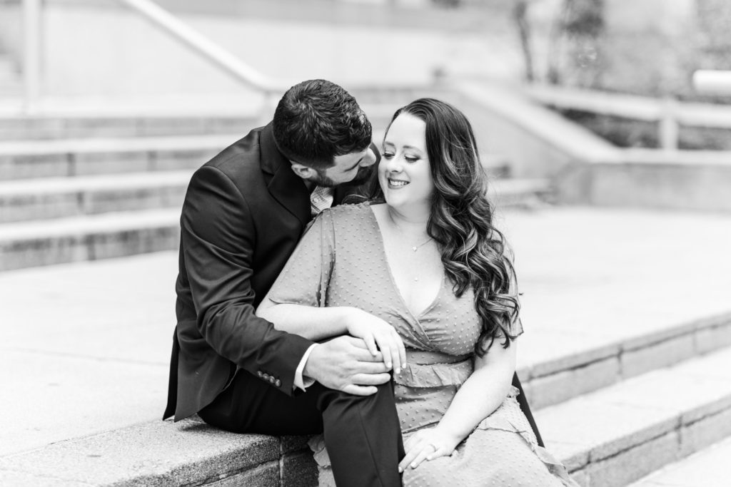 A couple snuggling for their Raleigh engagement photos