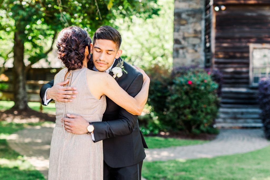 Groom and his mom sharing a sentimental moment at a wedding