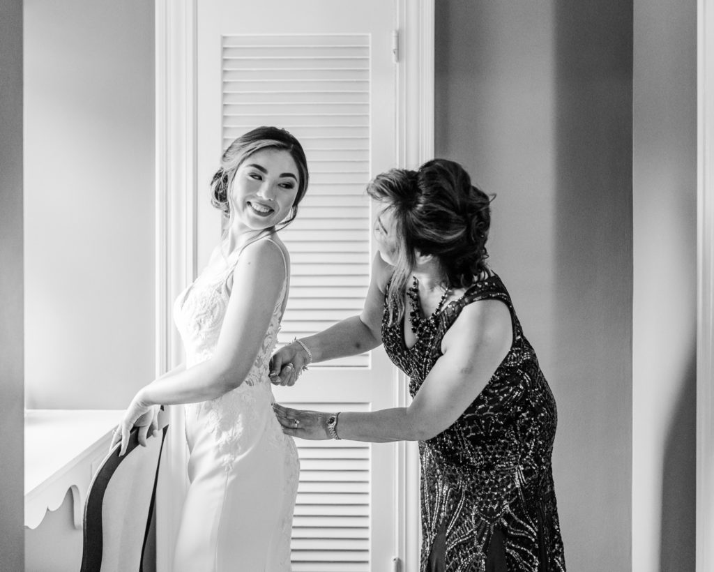 A bride getting into her dress on her wedding day