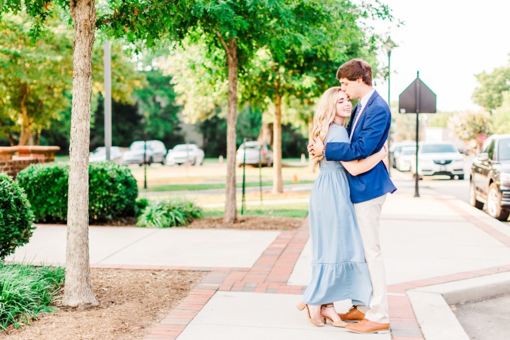 A couple snuggling for their engagement photos in Cary, NC