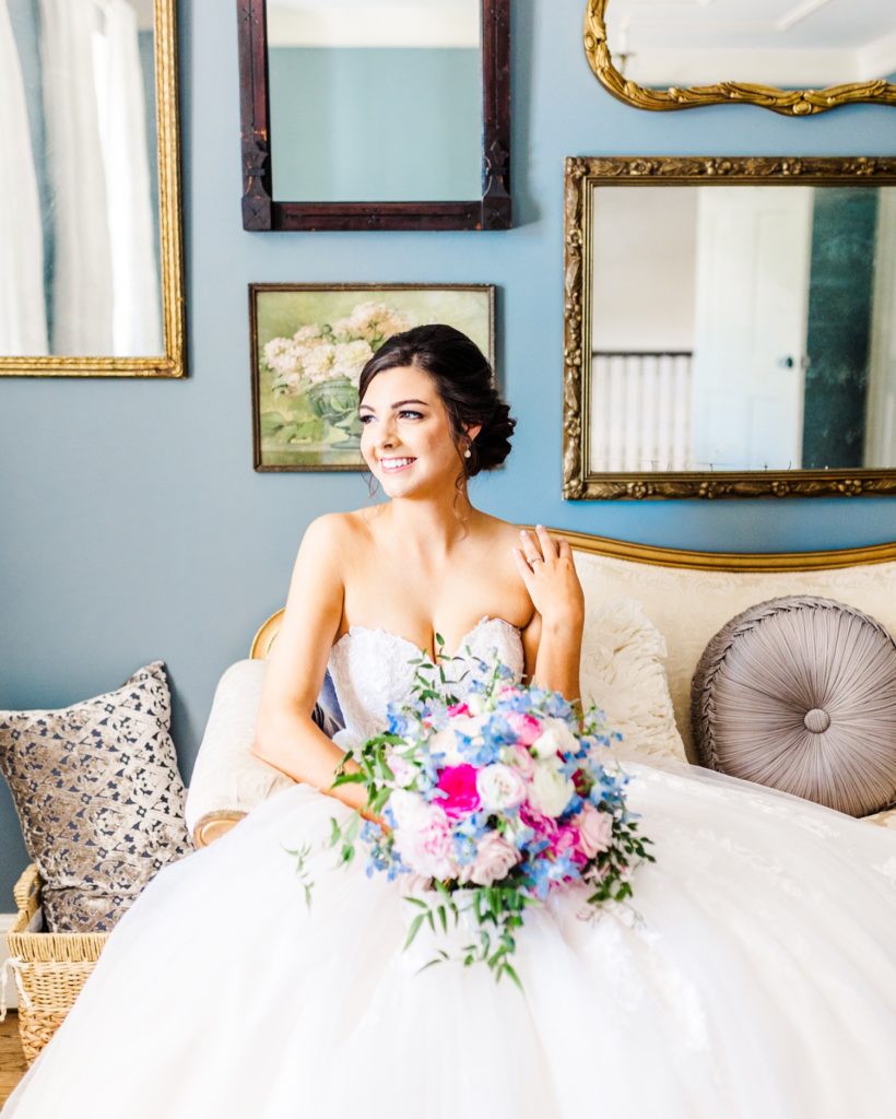 A bride holding her beautiful blue and pink bouquet from Flowers on Broad Street