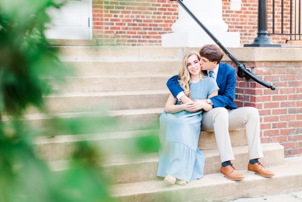 A couple sitting down during their engagement photos in Cary, NC