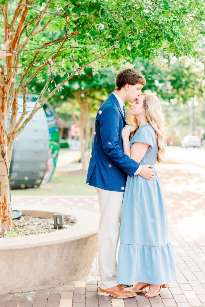 A couple kissing in downtown Cary, NC captured by Raleigh wedding photographer Tierney Riggs