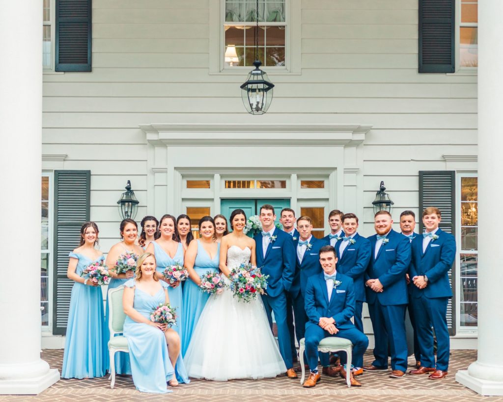A wedding party on the porch of Highgrove Estate