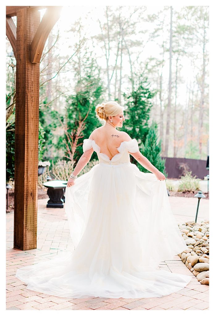 Bride twirling in her wedding dress by Raleigh wedding photographer Tierney Riggs