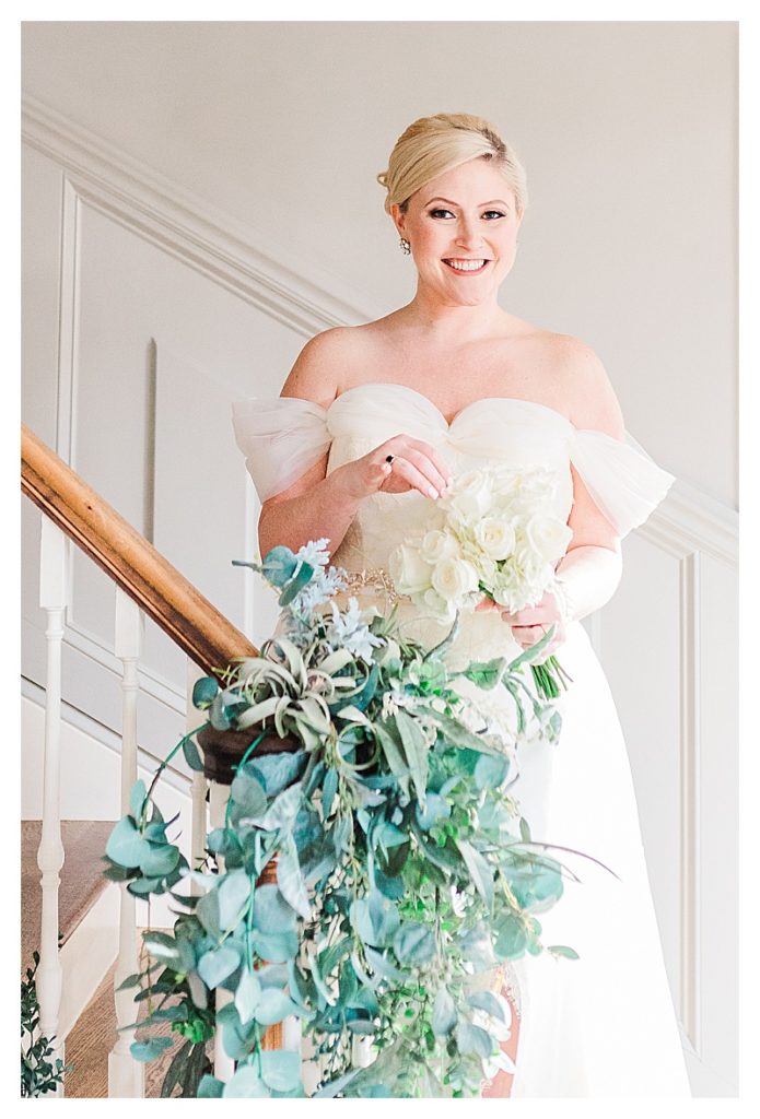 Bride holding an elegant white bouquet by Flowers on Broad Street