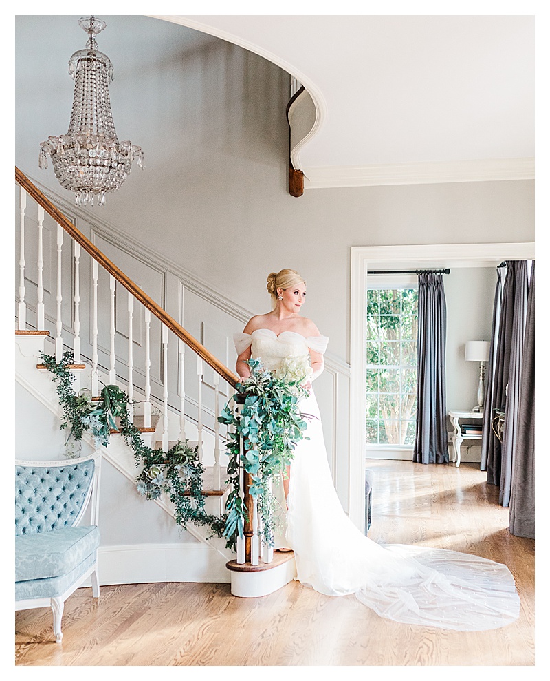 Bride posing for a bridal portrait on a staircase at Highgrove Estate