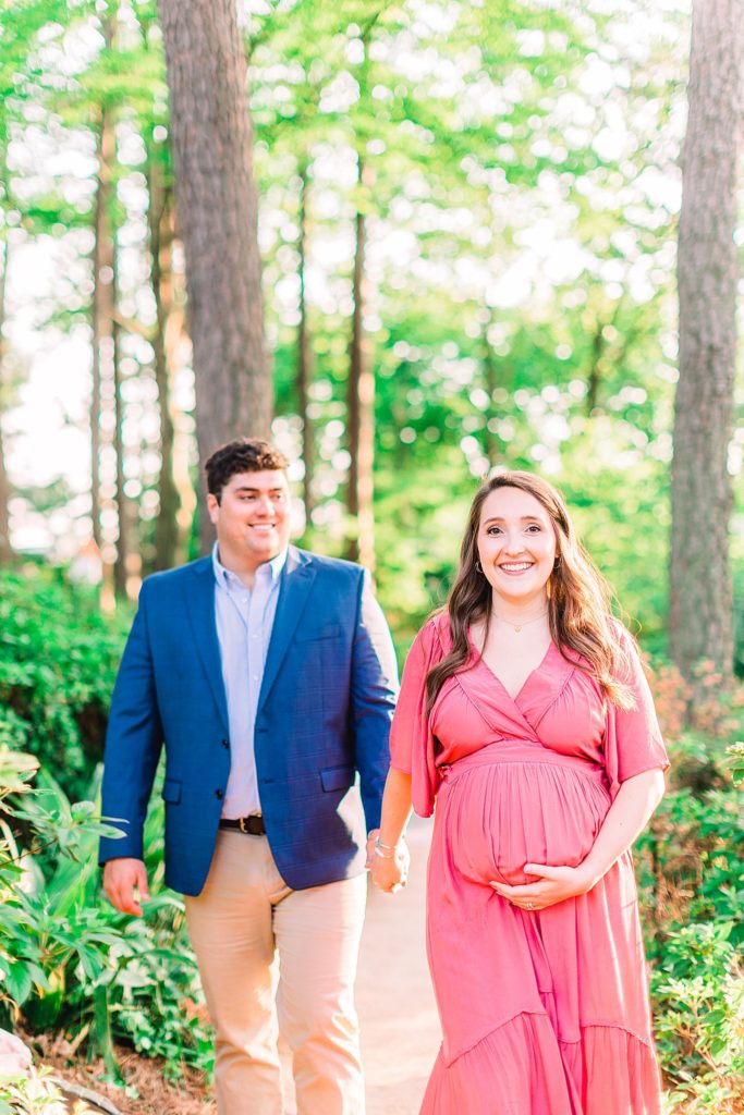 A couple walking around in a garden by Raleigh maternity photographer Tierney Riggs