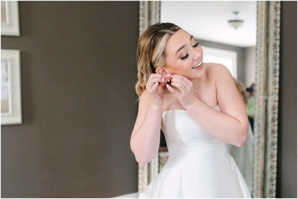 Bride putting on her earrings at the Sutherland