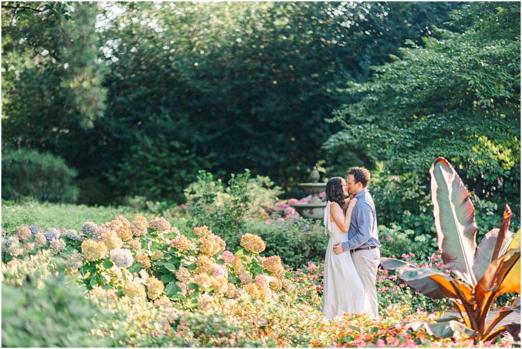 A couple kissing in the WRAL Azalea Gardens