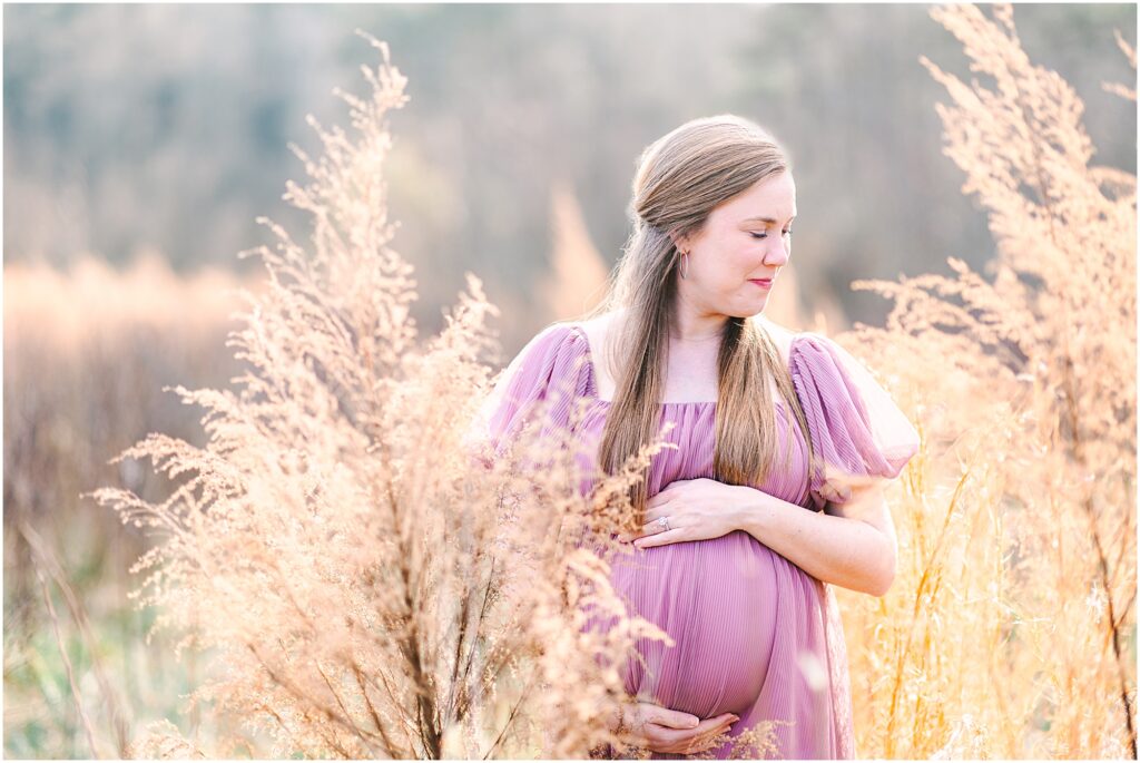 An expecting mother in a grassy field