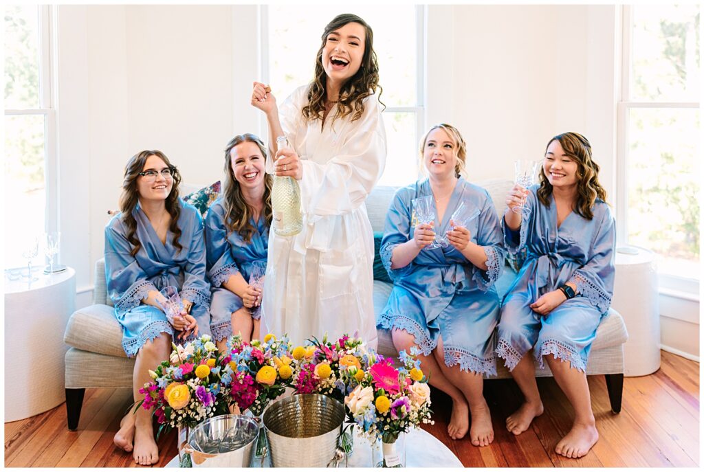 Bride celebrating with her bridesmaids on her wedding day