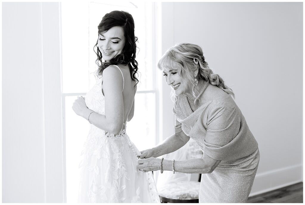 Bride putting on her wedding dress at the Upchurch in Cary, NC