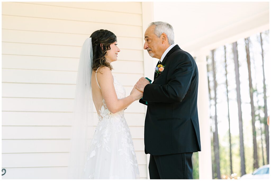 A father daughter first look on the front porch of the Upchurch