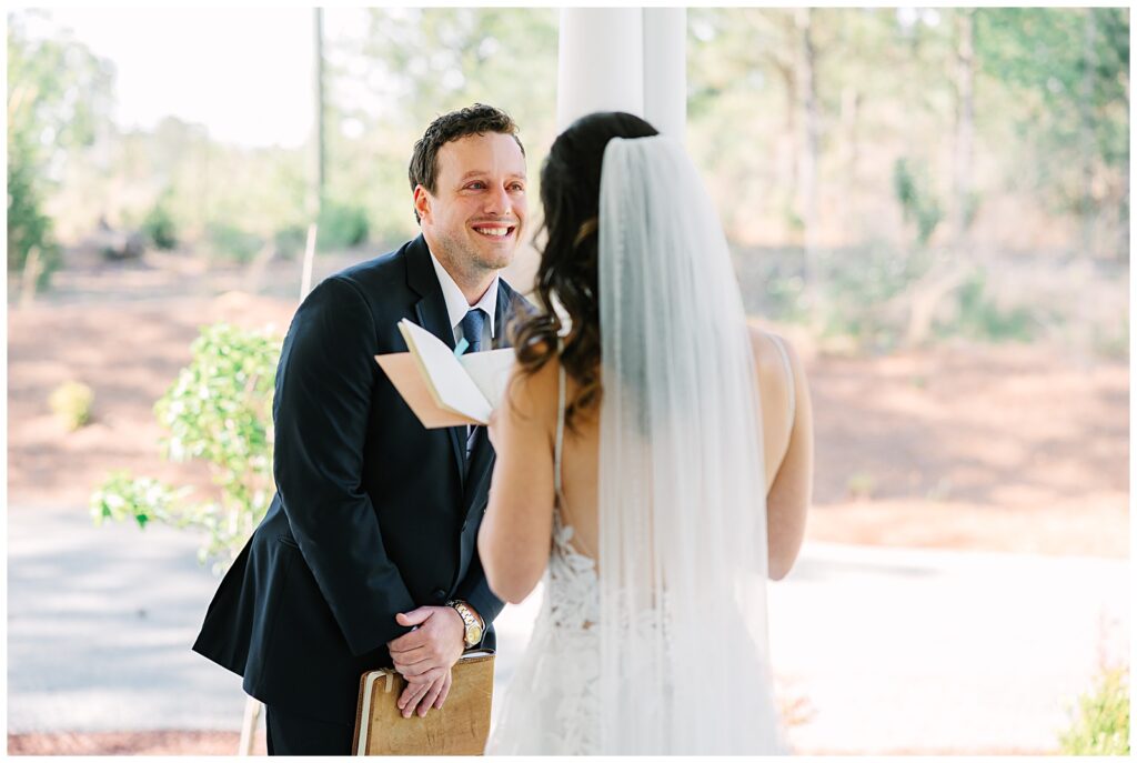 Vow exchange between a happy couple on their wedding day at the Upchurch wedding venue in Cary, NC