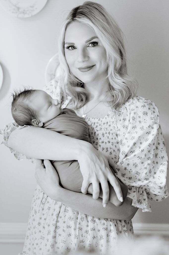 A mom snuggling her baby during their newborn phots 