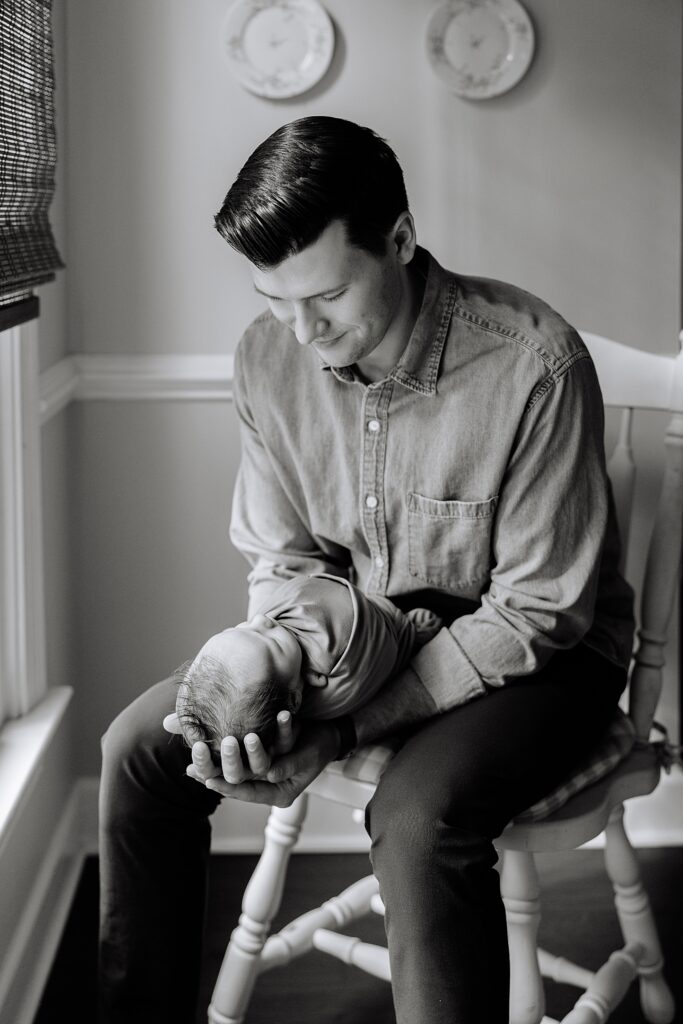 A dad and his baby son during their newborn photos taken by Raleigh newborn photographer, Tierney Riggs