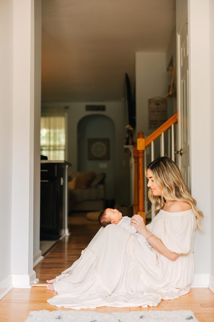 A couple in her home in Cary, NC taking photos with her sweet baby