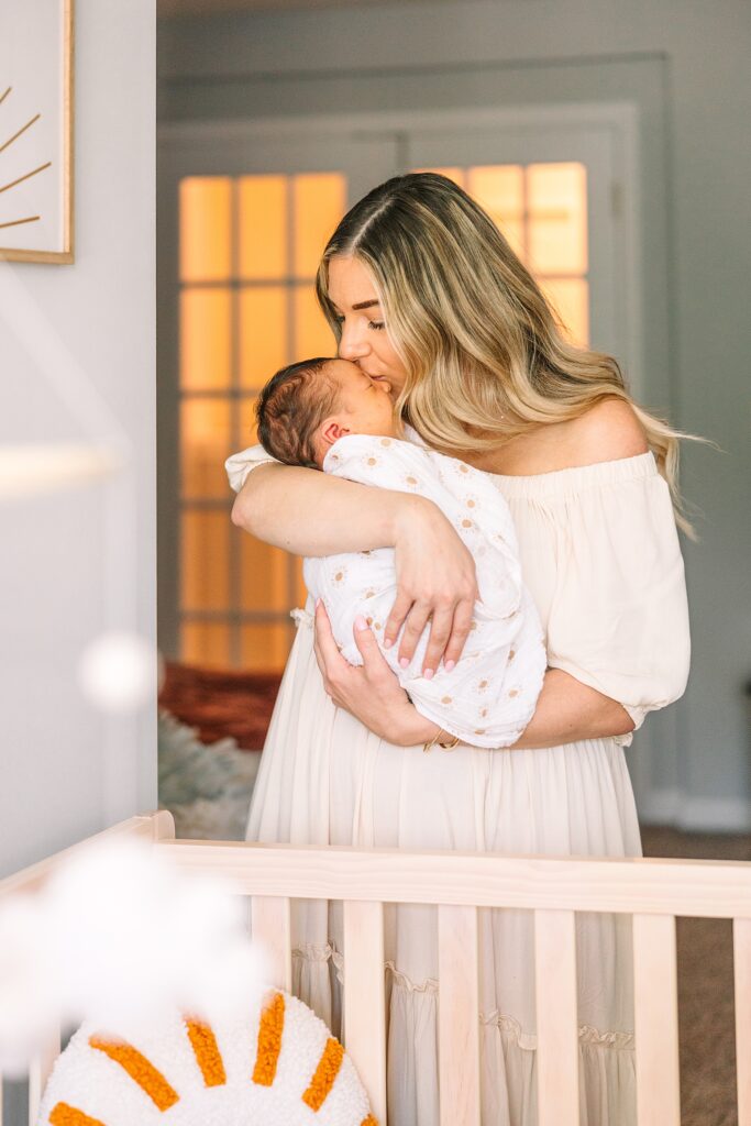 A couple in her home in Cary, NC taking photos with her sweet baby