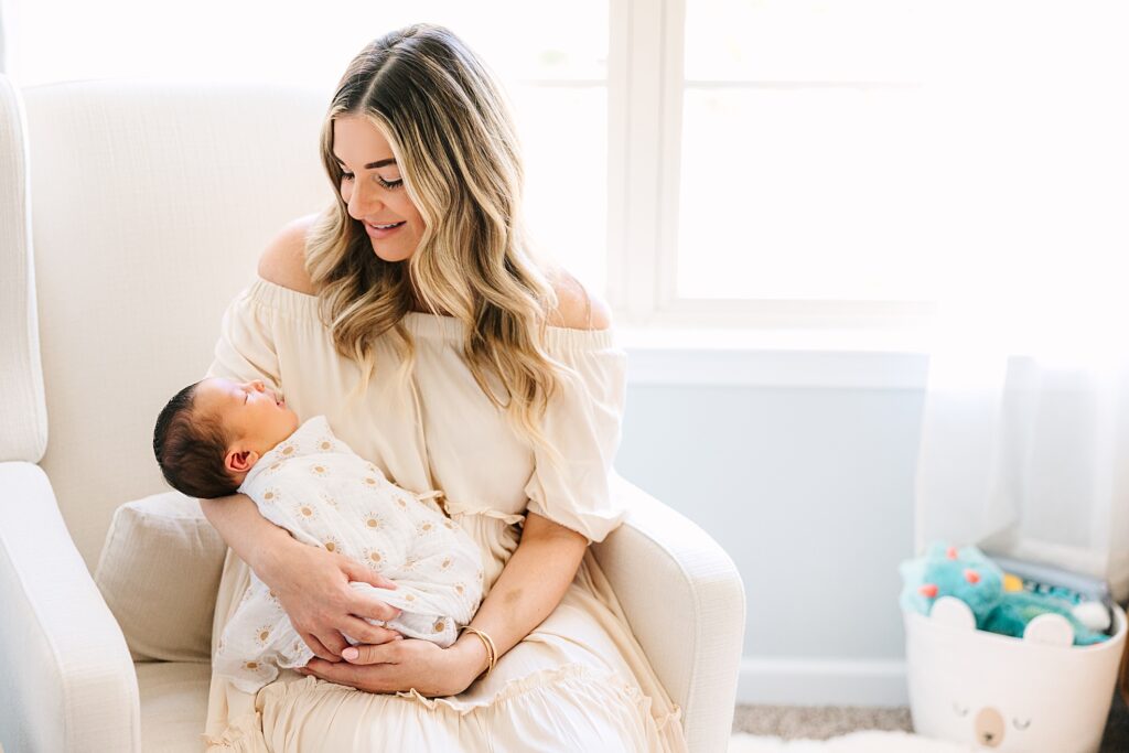 A couple in her home in Cary, NC taking photos with her sweet baby